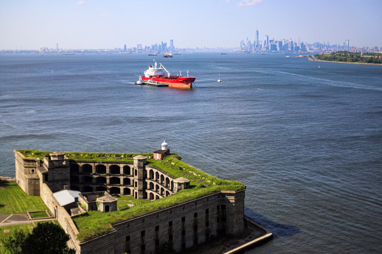 New York City skyline beyond Battery Weed, part of Gateway National Recreation Area New York City skyline from the Fort Wadsworth Overlook, Battery Weed and Boat in the background