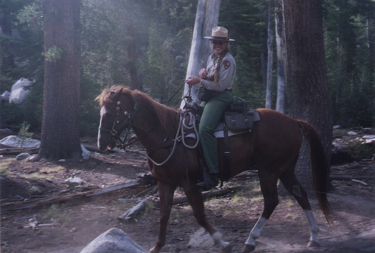 Laurel Boyers on horseback, Yosemite National Park Laurel Boyers on horseback surrounded by trees, wearing National Park Service uniform