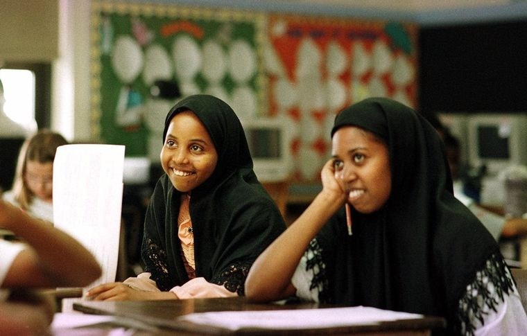 Immigrant Two women students smiling