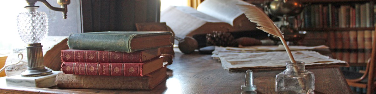 muirbooks Antique books and artifacts line desk