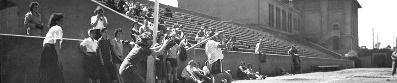 1944 WAVES and WACS game at Fort Mason, Golden Gate National Recreation Area. Image credit: NPS Black and white vintage photo of women playing baseball. A catcher stands behind the batter, who has just swung. The batter is wearing shorts. The catcher is wearing cropped pants. The other women are dressed in shirts and skirts.