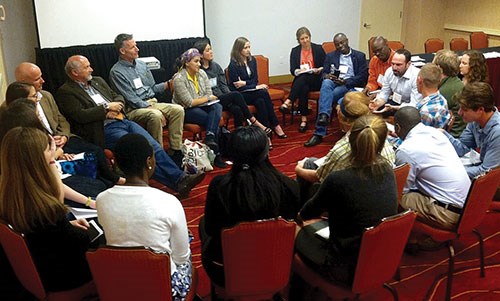 Approximately 20 people gather in a circle of chairs to participate in discussions about park and protected area careers