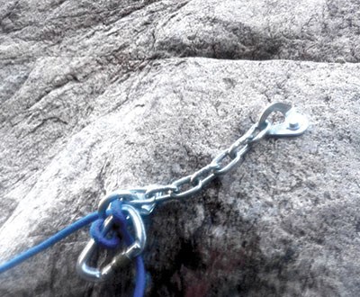 Permanent rappel anchor point with bolt, chain, carabiner, and rope