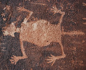Petroglyph at Newspaper Rock, Petrified Forest National Park. Image credit: NPS A light brown petroglyph of a creature with a tail on brown rock