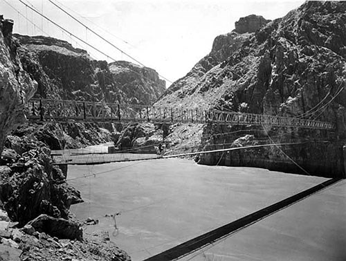 View of the 1921 swinging bridge and the 1928 Kaibab suspension bridge over the Colorado River around 1928, before the original bridge was removed.