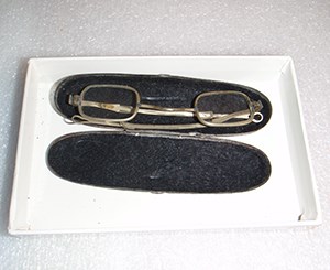 Eyeglasses with case from the 1800s. Fort Donelson National Battlefield. Image credit: NPS A pair of old eyeglasses in a pale metal frame in an oval glasses case with a black interior.