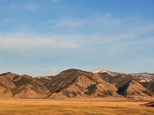 Orange colored mountains in a desert with blue sky