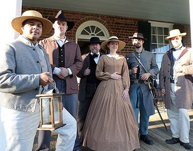 Appommatox 1865 Foundation members posing in period clothing during a living history lantern tour.