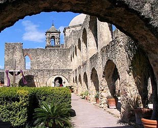 lt= A view of the landscaped grounds and Convento at Mission San Jose
