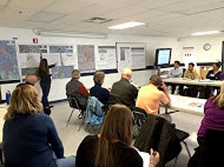 lt= Members of several organizations attend a design workshop.