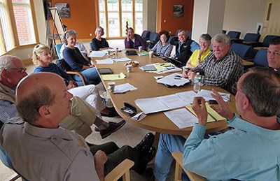 Members of the Friends of Acadia and National Park Service are gathered around a table during a meeting.