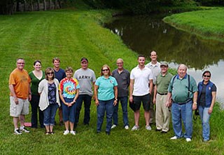 lt= Members of a planning team pose for a group photograph in Johnson Park near the Elkhorn River.