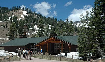 Kohm Yah-mah-nee Visitor Center Visitors exiting the Kohm Yah-mah-nee Visitor Center, surrounded by snow spotted mountains.