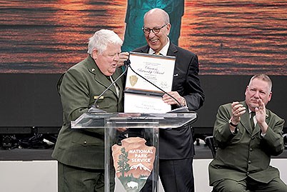 Stephen Briganti receiving the Director’s Partnership Award certificate from former Deputy Director Exercising the Authority of the Director, Daniel Smith.