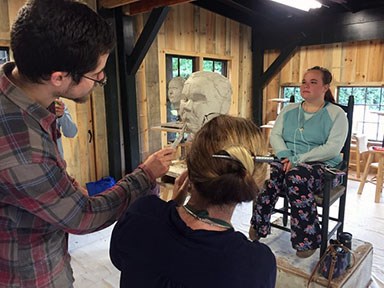 Sculptor Morgan Dummit teaches a portrait class during a workshop.