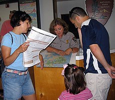 A Teacher Ranger assisting visitors in the Acadia National Park Visitor Center