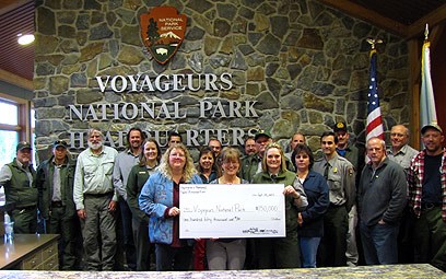 lt= Members of Voyageurs National Park Association present a Landmark Grant check to Voyageurs National Park employees.