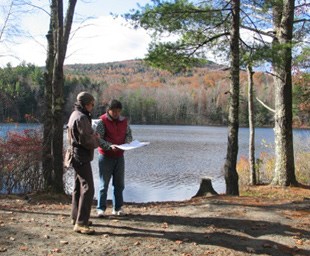 Two site planners visit the South Pond to obtain a lay of the land.