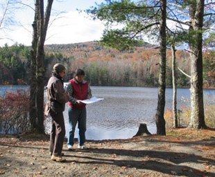 lt= Two site planners visit the South Pond to obtain a lay of the land.