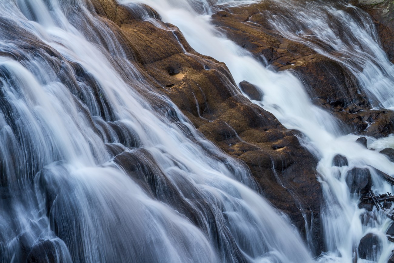 water flowing down a small waterfall