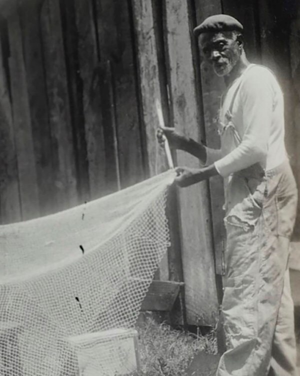 Sam Polite Sam Polite standing with a fishing net stretching the net out.