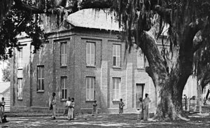 African American children in front of two story brick building