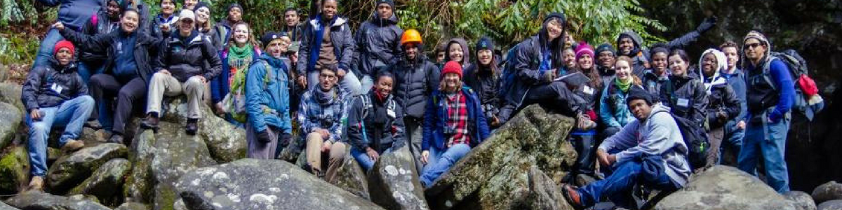 Members of SCA's NPS Academy take a break by one of Alaska's raging rivers.