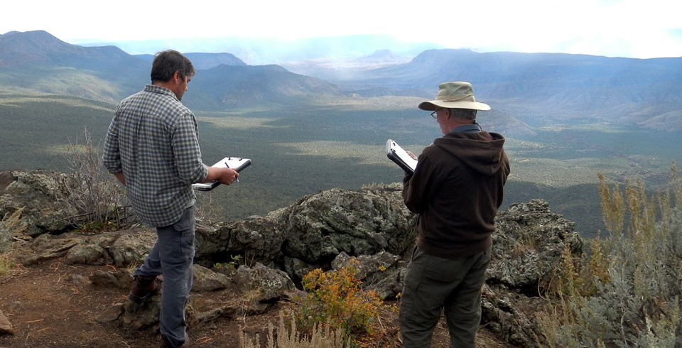 Two researchers doing science in the field