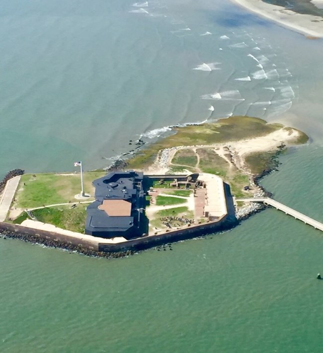 Aerial view of a fort on an island in the water.