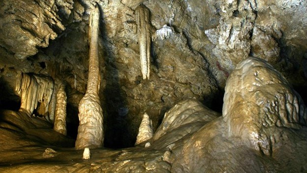 Tan rocks appear to be dripping in these cave formations of stalactites and stalagmites. Tan rocks appear to be dripping in these cave formations of stalactites and stalagmites.