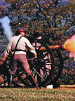 Costumed actors as Civil War soldiers fire the cannon during a battle reenactment Costumed actors as Civil War soldiers fire the cannon during a battle reenactment