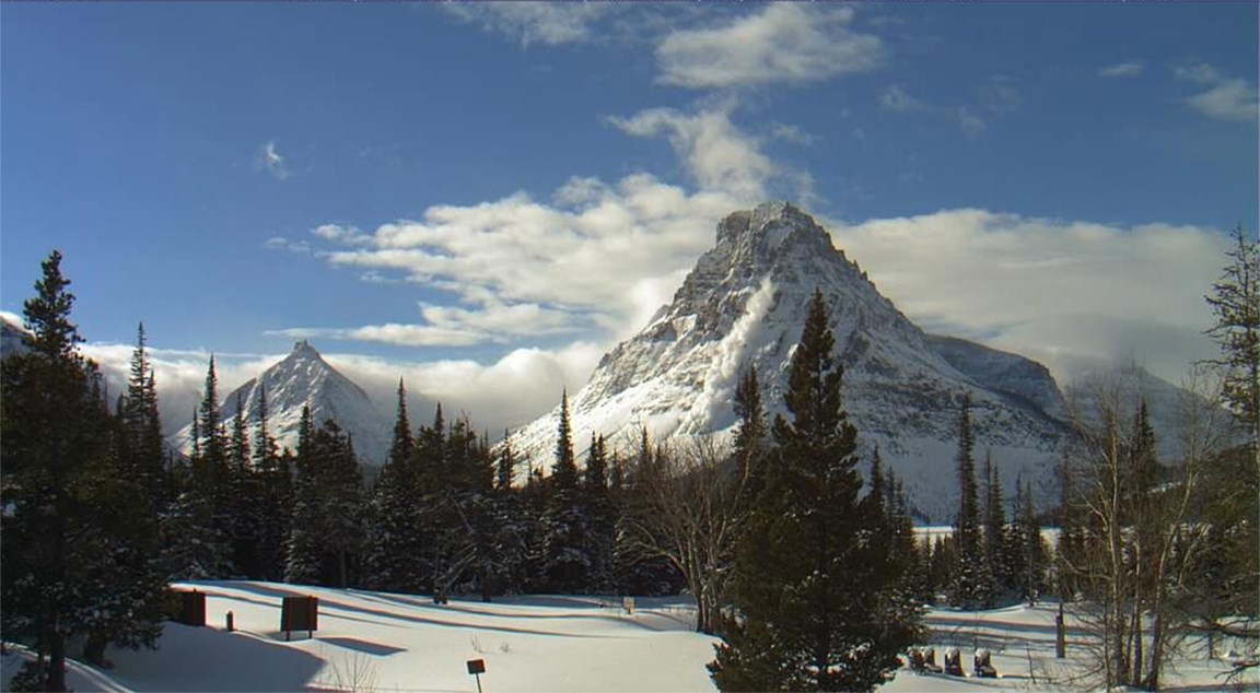 Snowy mountain peak shows avalanche in process at Grand Teton National Park, Wyoming.