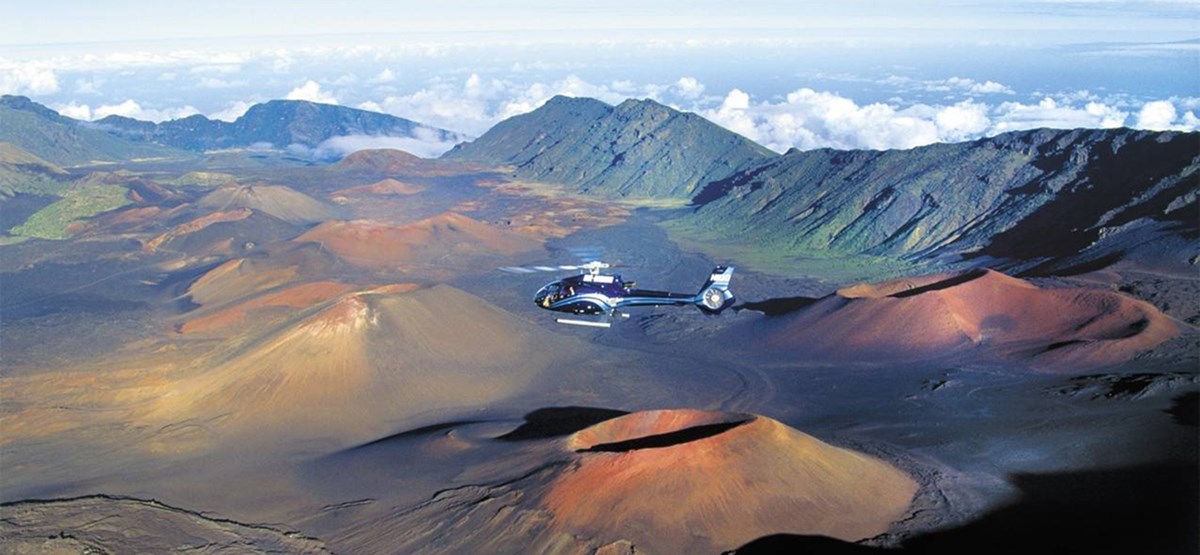 Side view of a helicopter in flight over the Haleakala volcano at Haleakala National Park, Hawaii.
