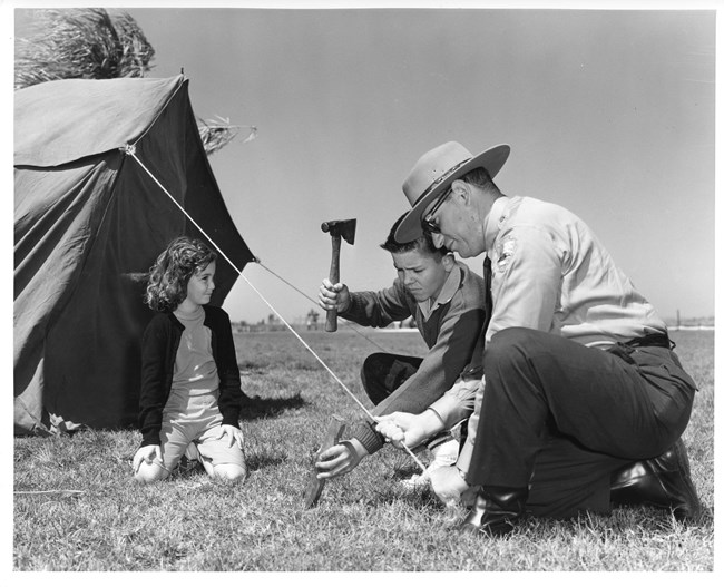 Boucher_Tent_EVER17073 A park ranger helps two young children set up a tent