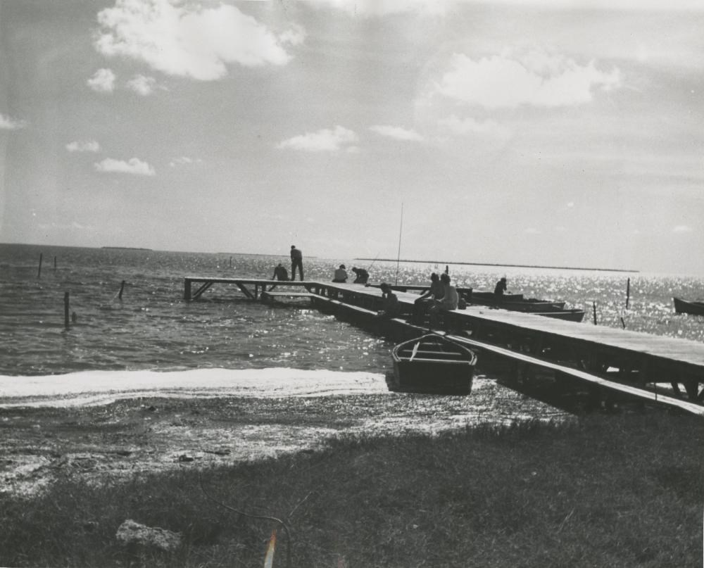 Group of people fishing off the Flamingo pier in 1938