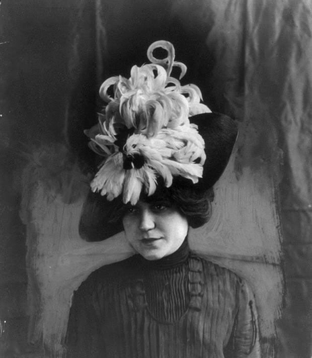 Woman wearing a plumed hat design