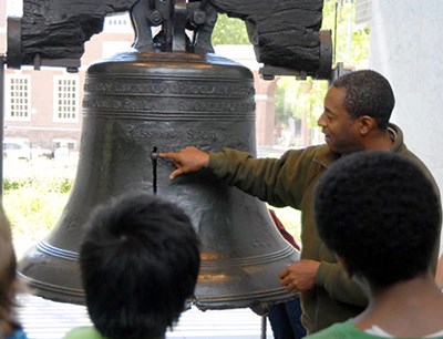 A National Park Service ranger shows visiting children the Liberty Bell. Students on field trips visit the park in large numbers, especially in the spring and fall. A National Park Service ranger shows visiting children the Liberty Bell. Students on field trips visit the park in large numbers, especially in the spring and fall.