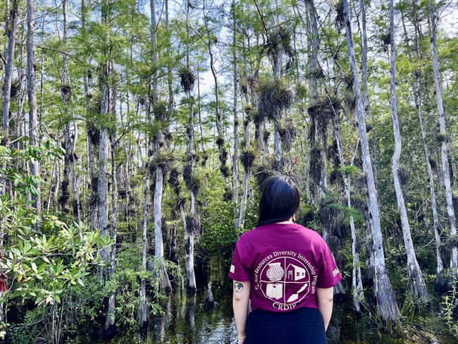 Woman with CRDIP shirt standing facing forward in the everglades wet lands