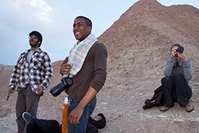 four young adults look at sky