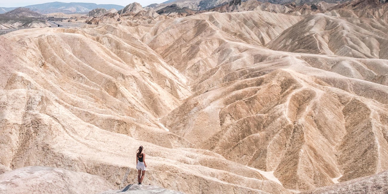A woman hikes through the hills of Death Valley