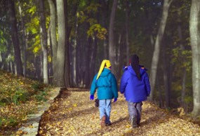 two kids walk in woods