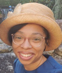 black woman with glasses and hat