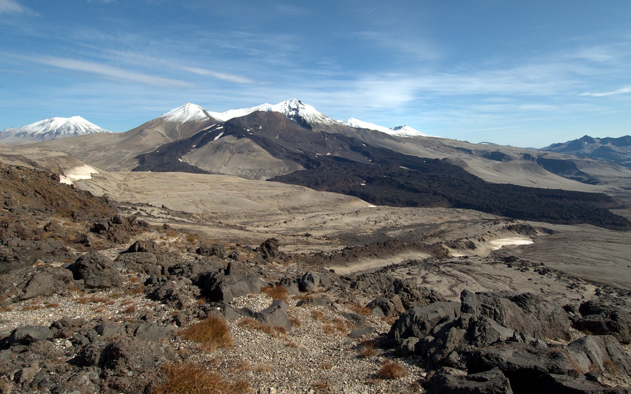 1252454659_ak147 photo of a mountainous landscape with dark lava flows on the slopes
