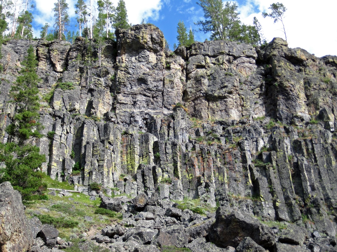 photo of rock cliff with vertical jointing