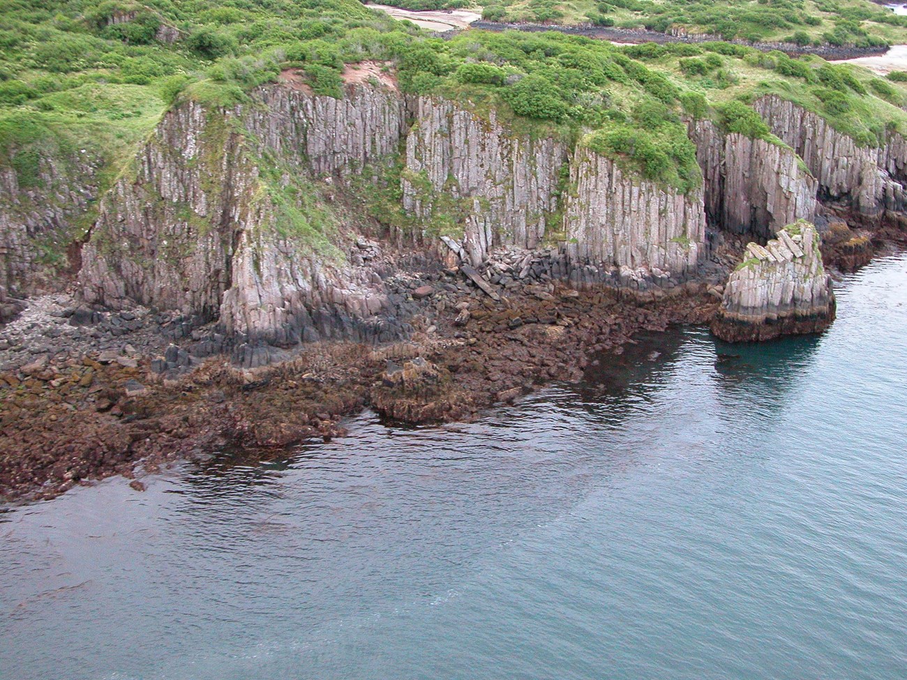 Columnar jointed lava flow of the volcanic rocks of the Barrier Range on Takli Island in Amalik Bay. Katmai National Park & Preserve, Alaska.