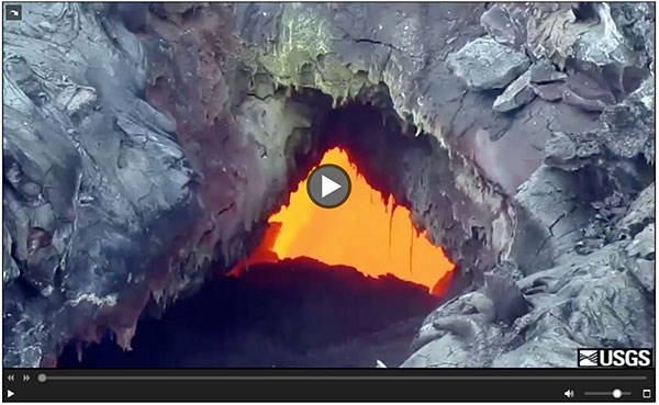 Screen capture of online video play frame with image of molten lava seen through a hole in the ground.