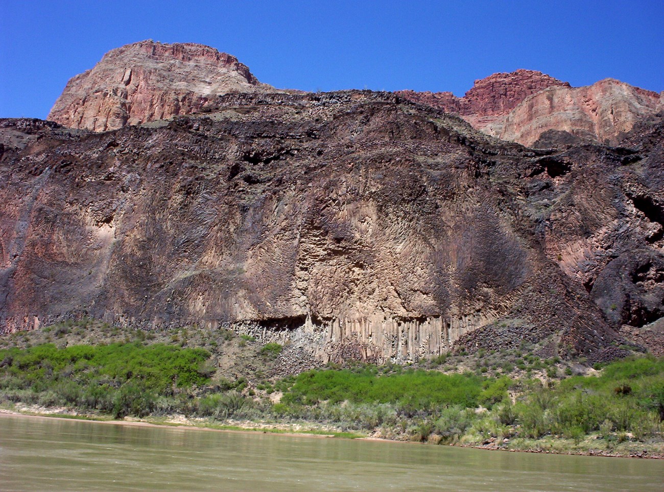Grand Canyon Columnar Jointing-adjusted photo of river side cliff with rock jointing