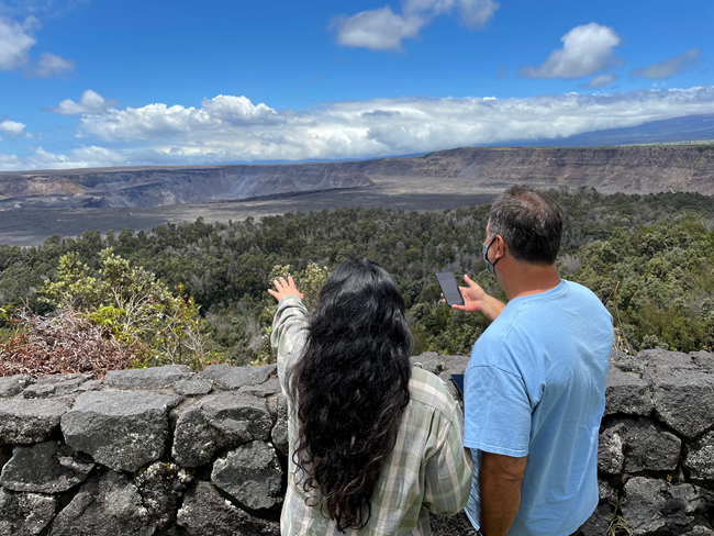 HAVO visitors at crater nps mobile app NPS Photo B.Hayes two visitors at volcanic crater using a mobile phone
