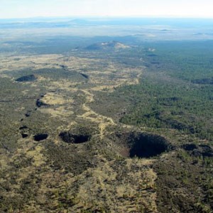 Aerial photo of a volcanic landscape with lava tube collapse openings.