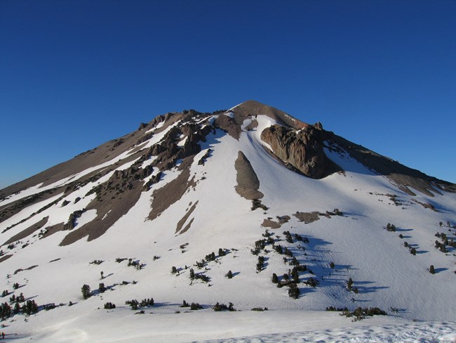 volcanic peak with snow covered slopes
